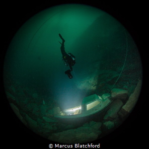 Diver scoots towards the blinding light by Marcus Blatchford 